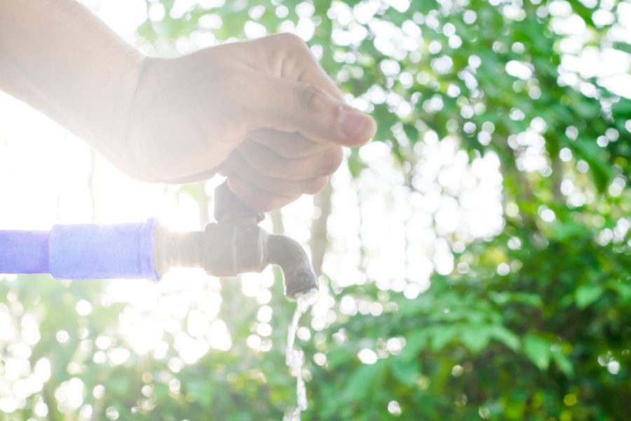 Shutting off the main outdoor water supply valve, an essential travel preparation step recommended by Putman & Son’s Plumbing.
