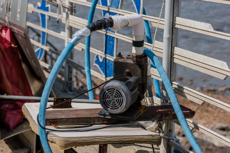 Portable emergency backup sump pump with hose attachments, a key defense against basement flooding recommended by Putman & Son’s Plumbing.