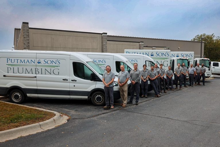 Putman & Son's Plumbing building in Rochester Hills, Michigan, with company service vans parked out front.