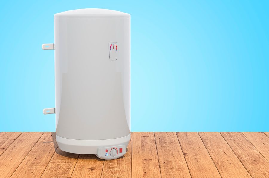 Electric water heater tank sitting on wood planks