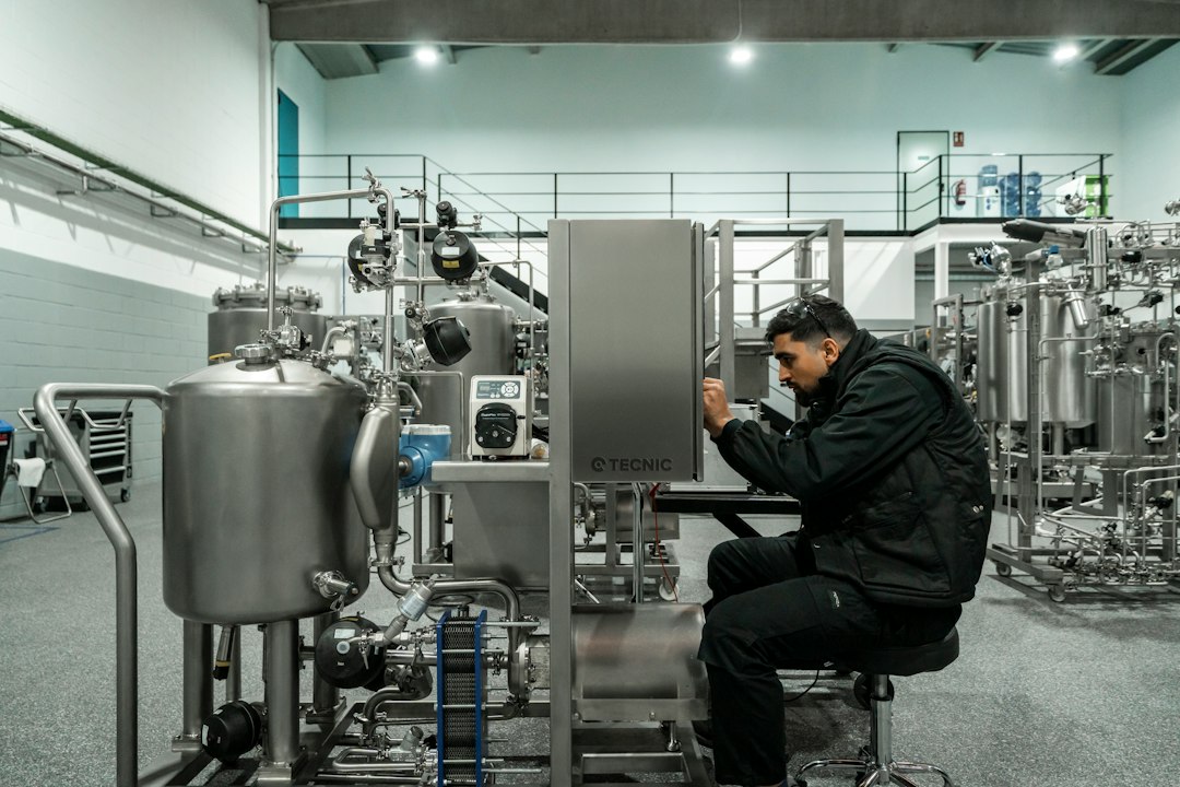 Technician performing maintenance in a commercial mechanical facility